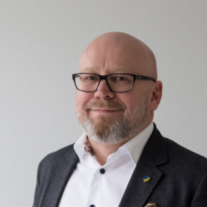 a smiling man with glasses