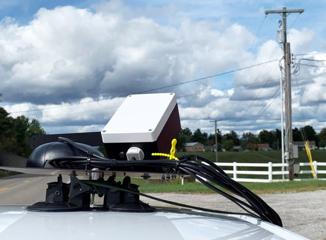 AI-powered camera system mounted on vehicle for grid infrastructure assessment
